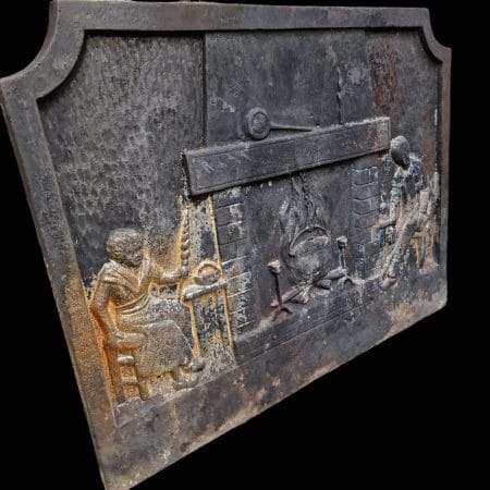 Vecchia piastra in ghisa da camino con soggetto antico focolare